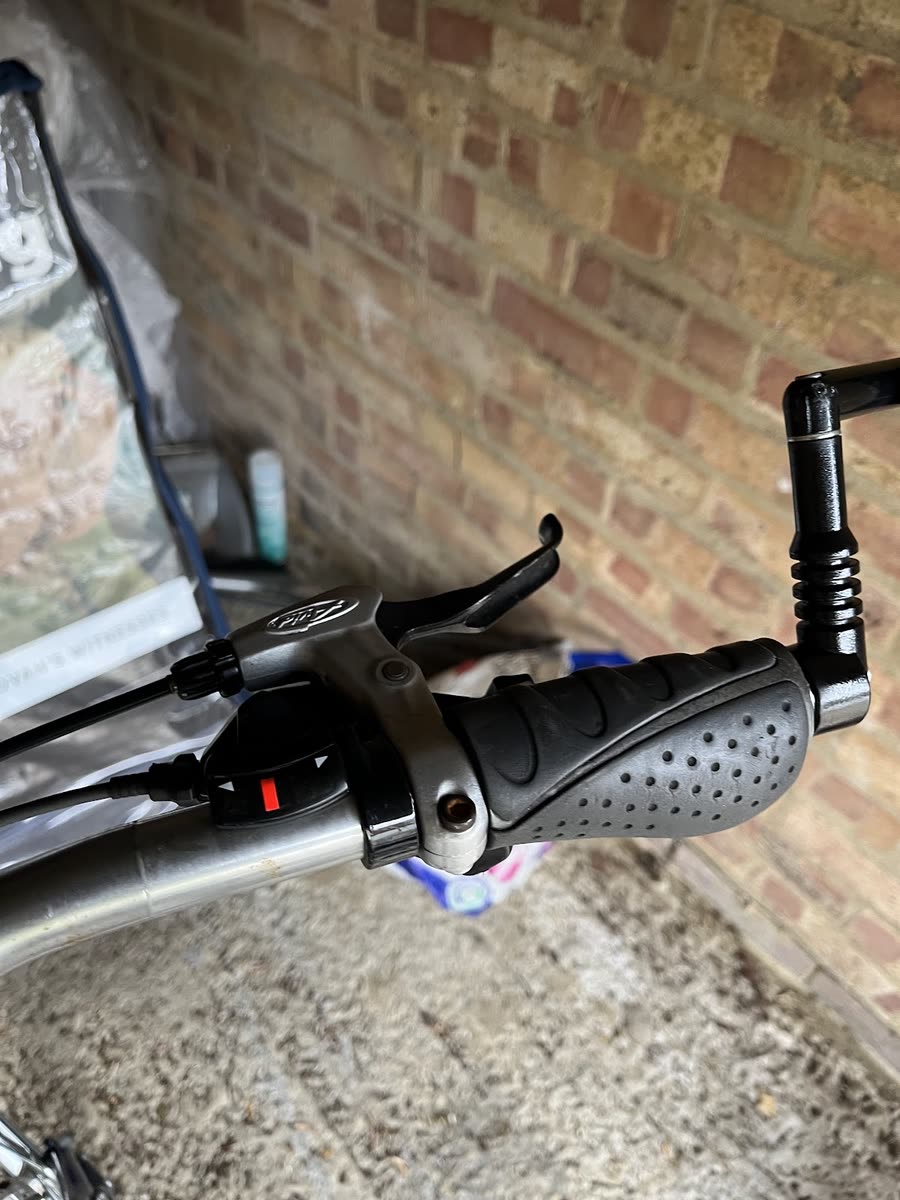 Close-up of a handlebar grip, brake lever and gear shifter